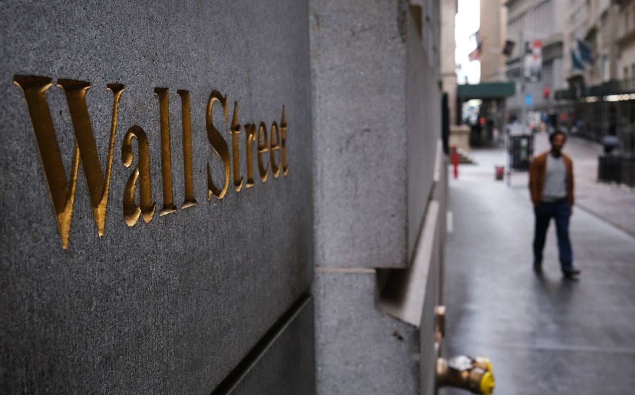 A person walks on Wall Street as the coronavirus keeps financial markets and businesses mostly closed on May 8, in New York City.