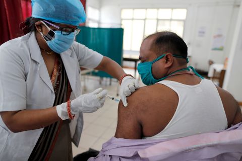 A health worker inoculates a man with a dose of the Covishield vaccine for Covid-19 at the Railway Hospital in Prayagraj, India, on April 28