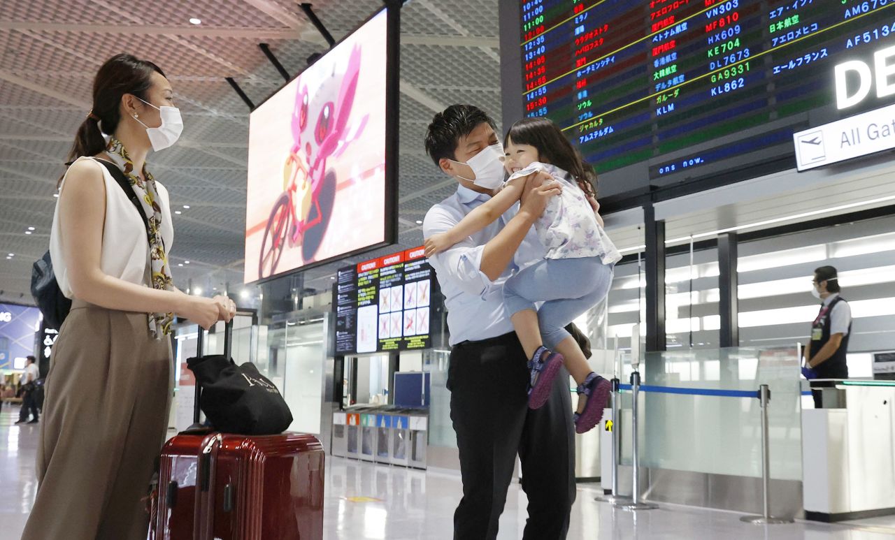 Daiki Murakami hugs his daughter Yurina as he is seen off by his wife Akina (L) at Narita airport near Tokyo on June 25, 2020, before boarding a chartered flight to Vietnam for business. 