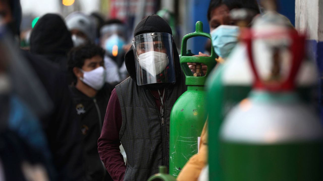 People in Lima, Peru, wait in line to refill oxygen tanks on August 3.