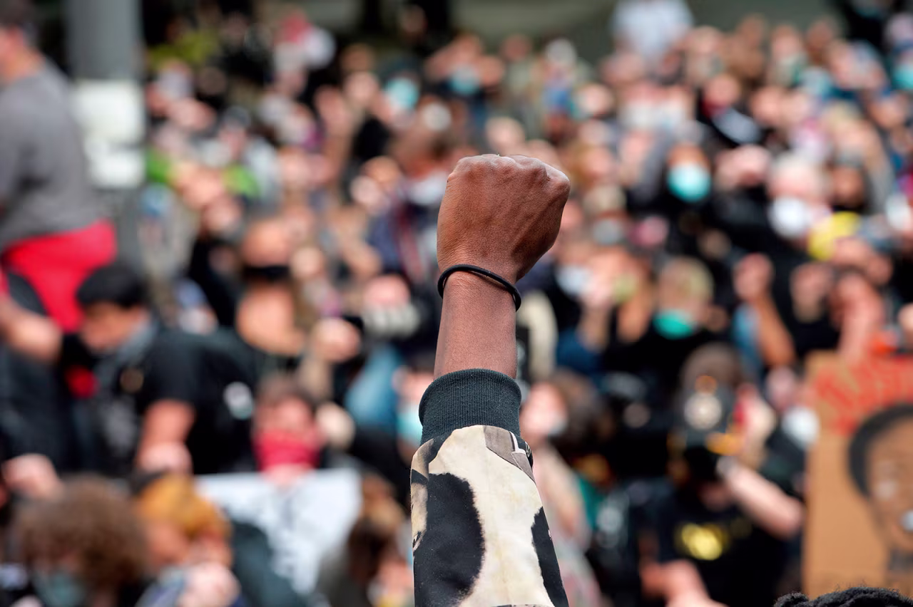 Protesters take a knee and raise their fists in a moment of silence for George Floyd and other victims of police brutality in Boston, Massachusetts on June 7.