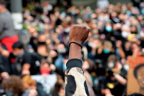 Protesters take a knee and raise their fists in a moment of silence for George Floyd and other victims of police brutality in Boston, Massachusetts on June 7.