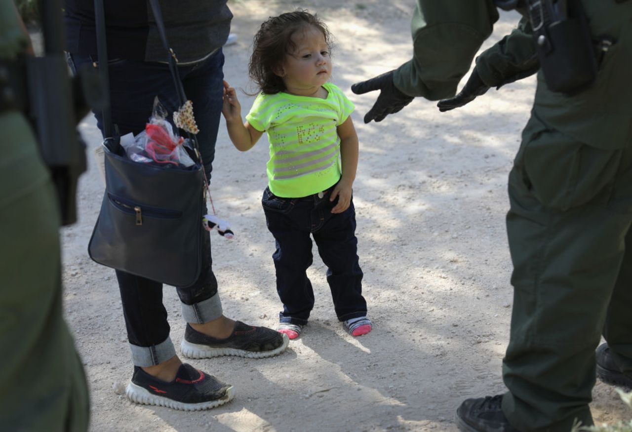 Border Patrol agents take Central American asylum seekers into custody on June 12, 2018 near McAllen, Texas. The immigrant families were then sent to a U.S. Customs and Border Protection (CBP) processing center for possible separation.