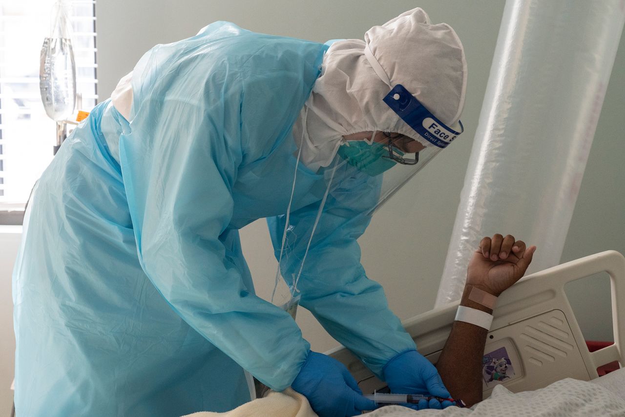 A medical worker takes a blood sample from a Covid-19 patient in the intensive care unit at the United Memorial Medical Center in Houston, on November 22.