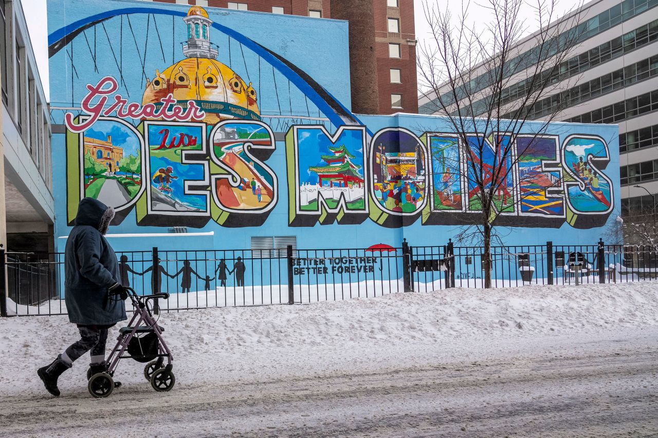 A person walks past a mural in downtown Des Moines, Iowa, on Saturday.