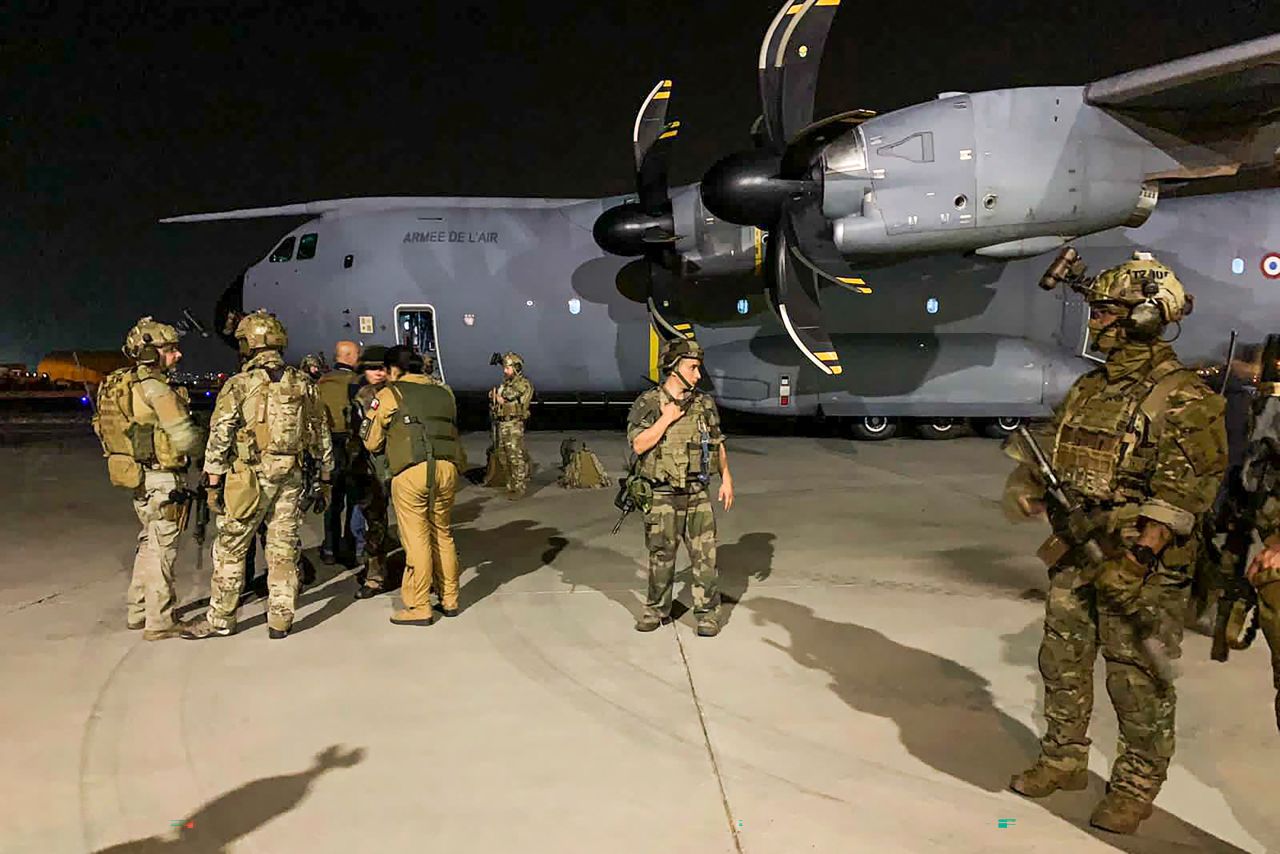 French soldiers stand guard near a military plane in Kabul, on August 17. 