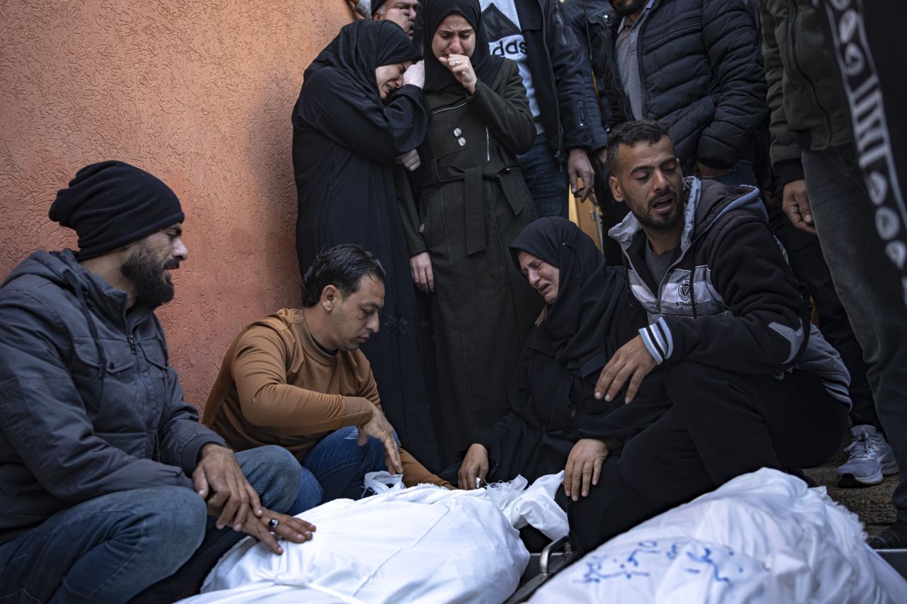 Palestinians mourn their relatives killed in the Israeli bombing of Gaza, at a hospital in Khan Yunis on Saturday, December 2.