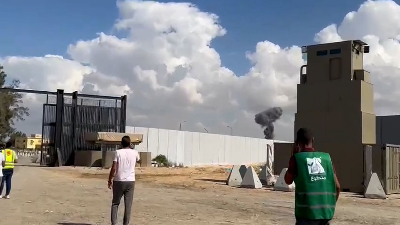 A plume of smoke rises beyond the Rafah crossing main gate, as seen in this screen grab taken from video filmed on the Egyptian side of the border.