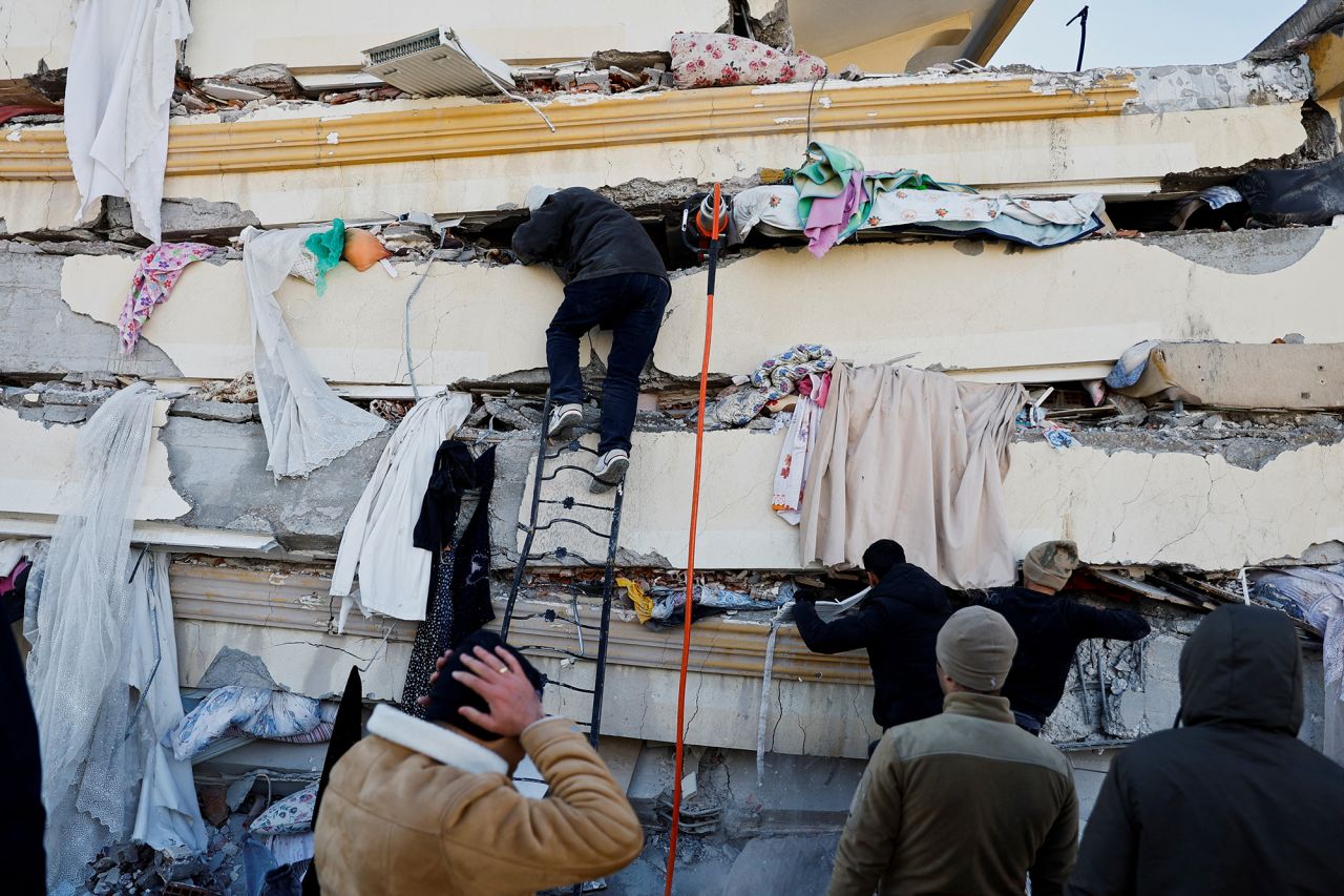 People search in the rubble at the site of a collapsed building following an?earthquake?in Kahramanmaras, Turkey, on February 7.