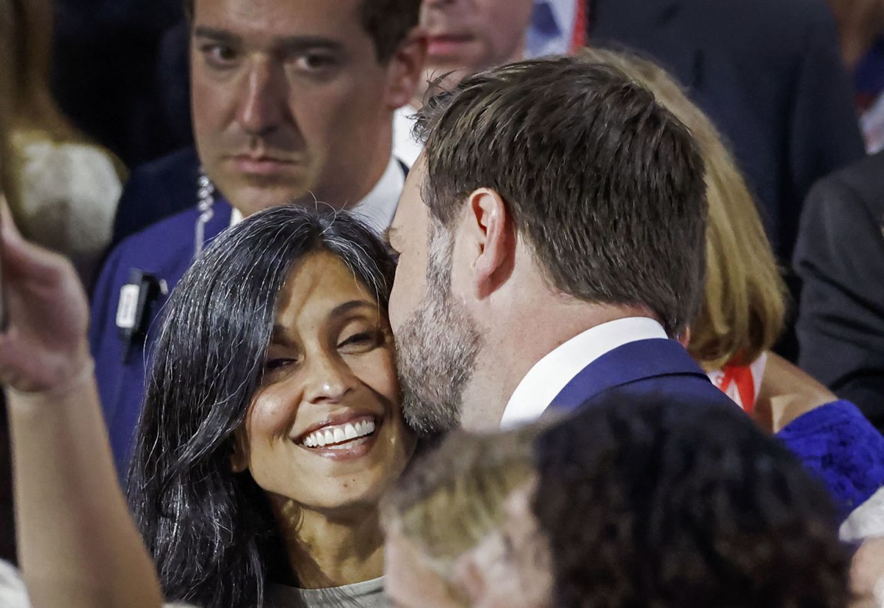 Sen. J.D. Vance kisses his wife Usha  as they arrive at the convention on Monday, July 15.