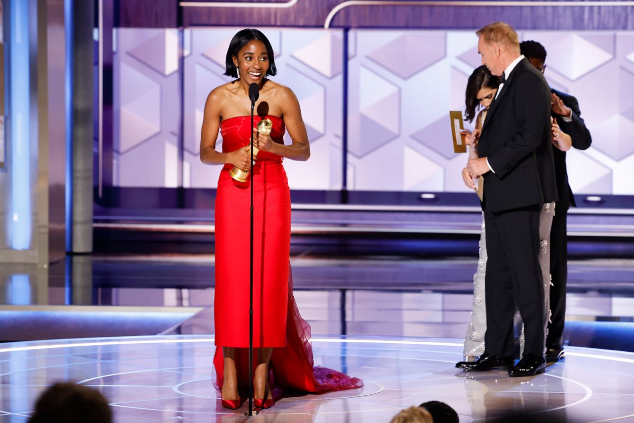 Ayo Edebiri accepts her Golden Globe award. 