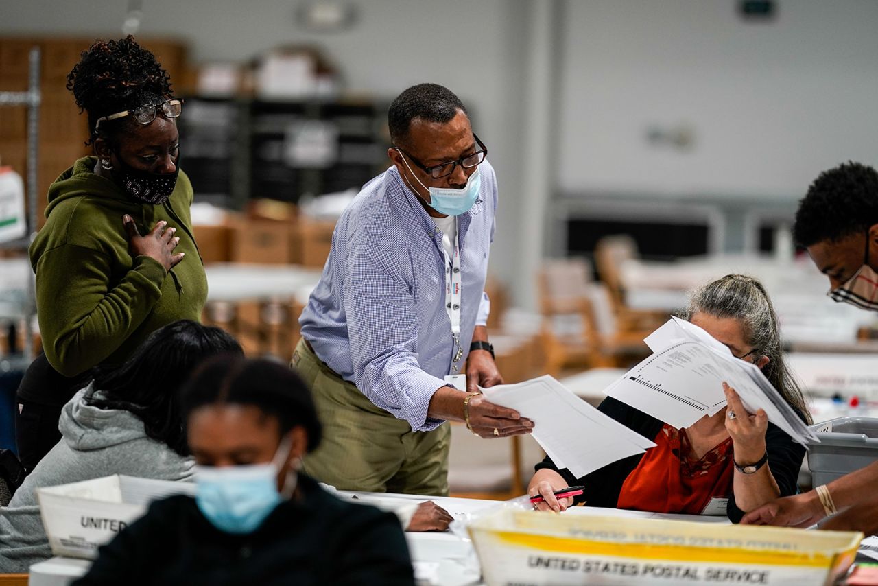 Election workers validate ballots at the Gwinnete County Elections Office on Friday, Nov. 6, in Lawrenceville, GA. 