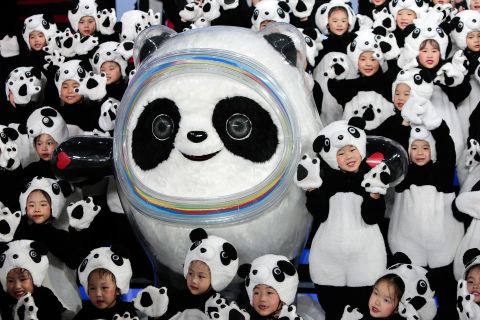 Olympic mascot Bing Dwen Dwen seen here with a group of children dressed as pandas.