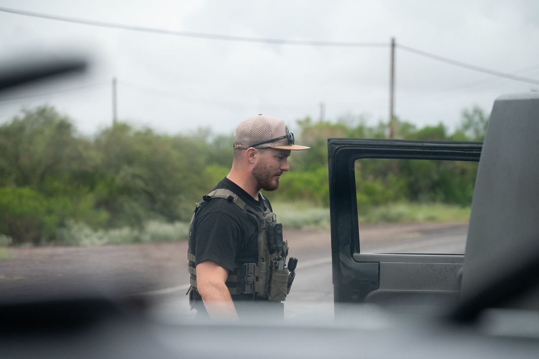 An officer stops a car as part of an operation against smugglers.