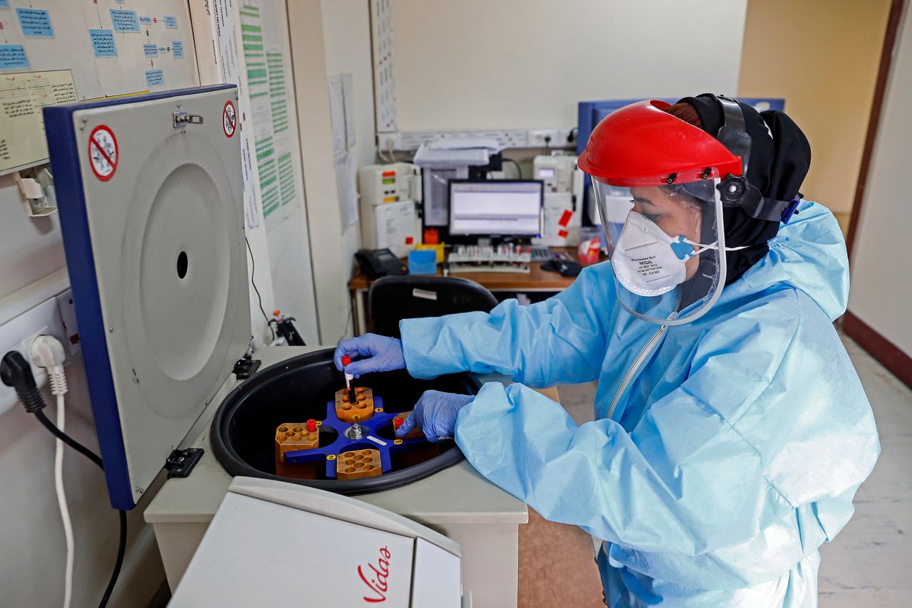 A paramedic works with a centrifuge to test blood samples taken from patients suspected of being infected with the new coronavirus, at a hospital in Tehran, Iran, on Sunday, March 1. 