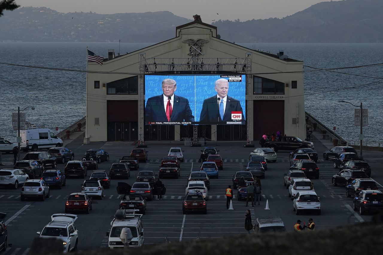 People watch from their vehicles as President Donald Trump, on left of video screen, and Democratic presidential candidate Joe Biden speak during a Presidential Debate Watch Party at Fort Mason Center in San Francisco, on Thursday.