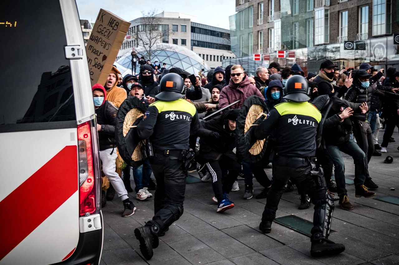 Protesters clash with anti-riot police officers during a demonstration against coronavirus restrictions in Eindhoven on January 24. 