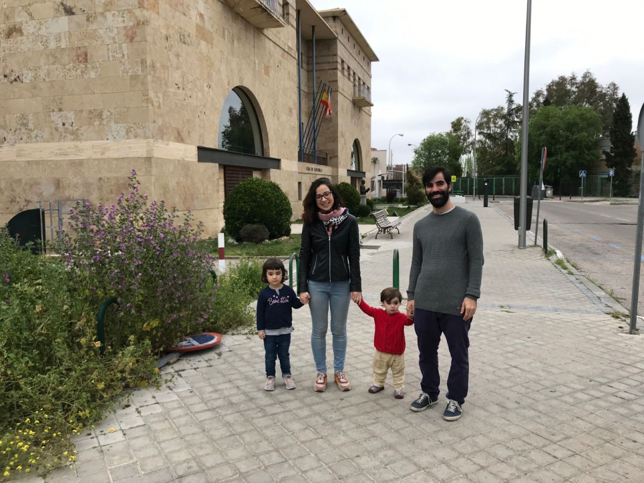 A couple walks with their two young children on Sunday. 