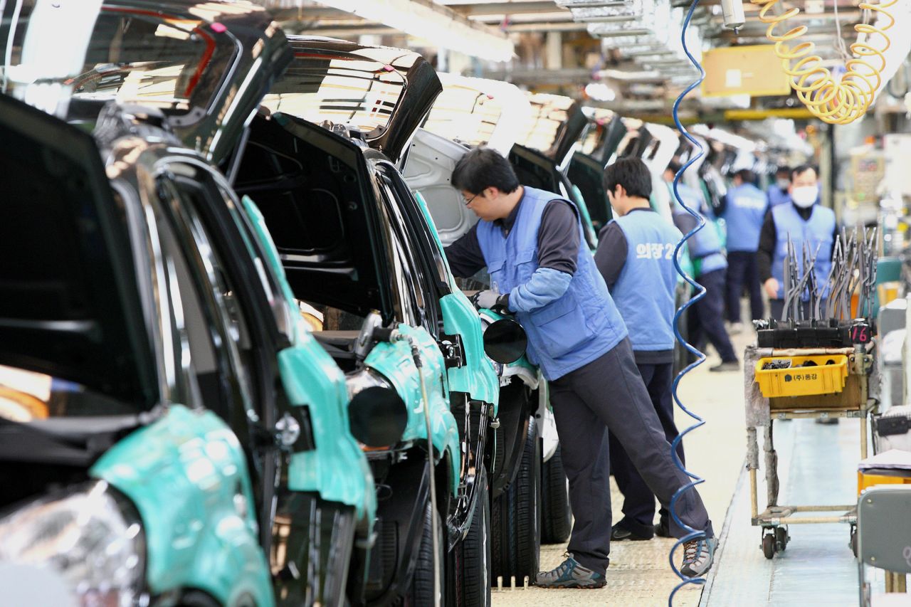 In this 2009 photo, workers work on an assembly line at Hyundai Motor Co. plant in Ulsan, south of Seoul, South Korea. The Hyundai Motor Company is suspending production lines at its plants in South Korea, after its supply of parts was disrupted because of the coronavirus outbreak in China. 