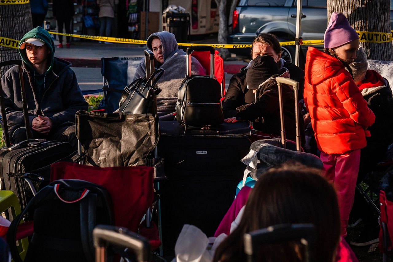 Ukrainian refugees wait near the San Ysidro Port of Entry at the US-Mexico border on Monday, April 4, in Tijuana, Mexico.?