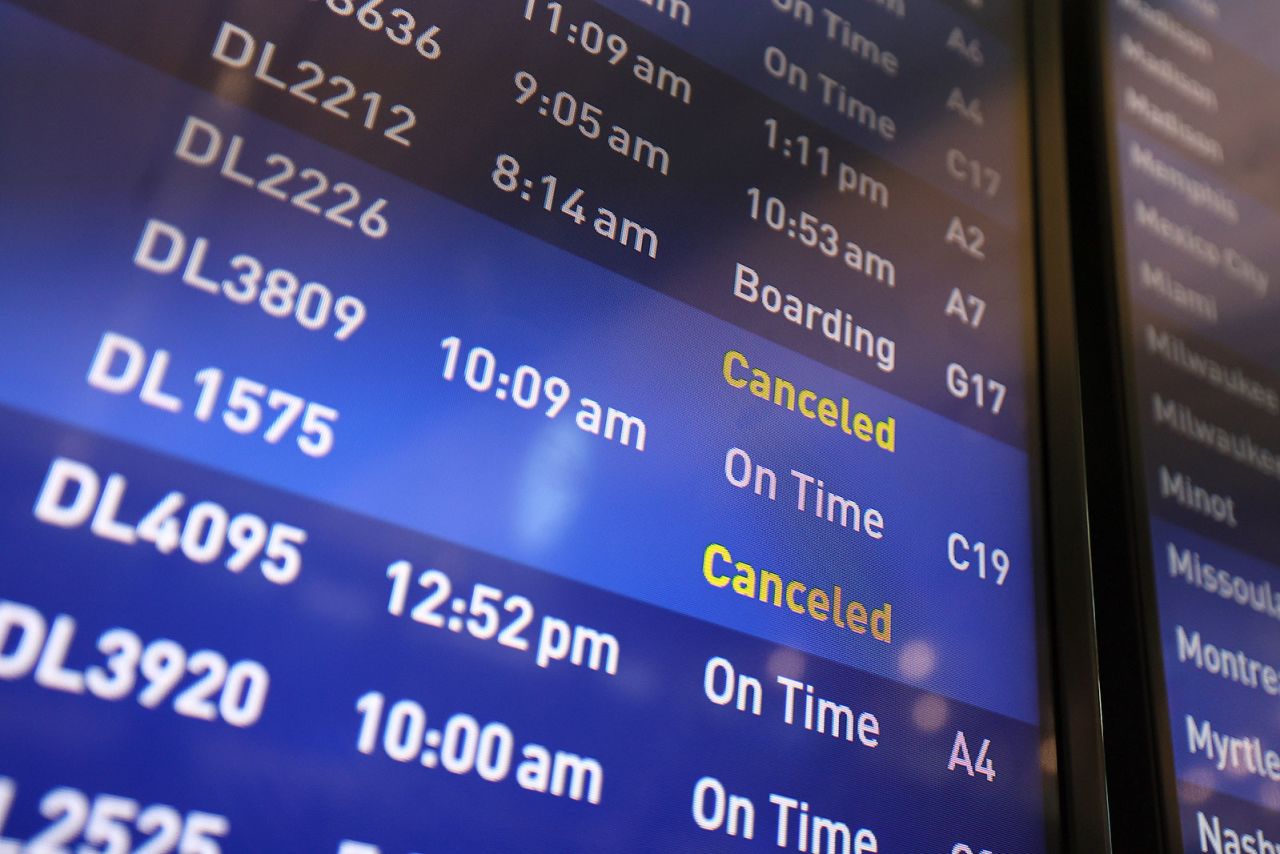 Flight boards show delayed or canceled flights at Minneapolis/St. Paul International airport on Friday, July 19, in Minneapolis. 