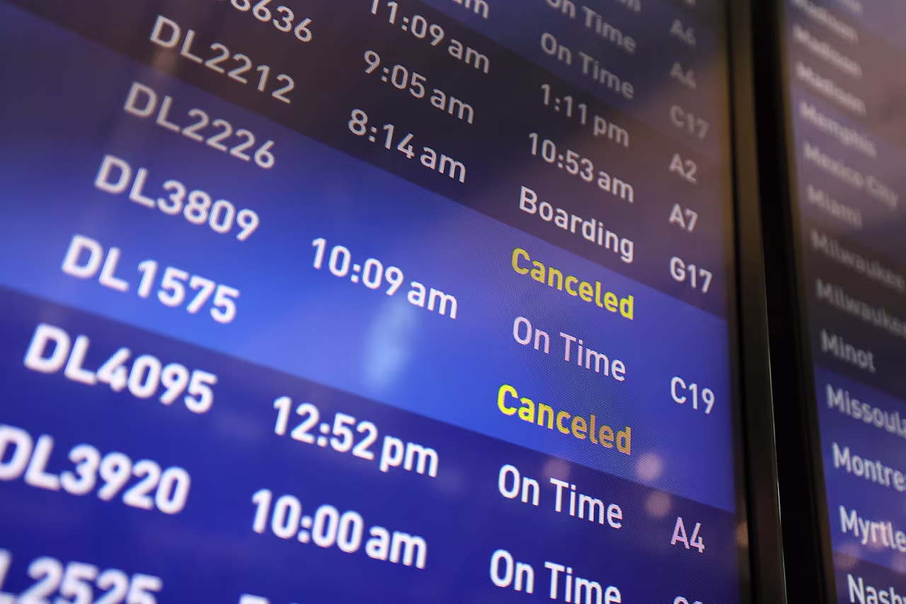 Flight boards show delayed or canceled flights at Minneapolis/St. Paul International airport on Friday, July 19, in Minneapolis. 