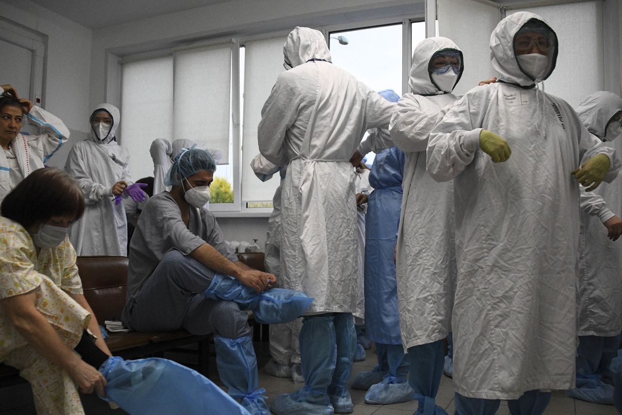 Medical workers put on protective gear at a temporary medical facility established for COVID-19 patients at Moscow City Clinical Hospital in Moscow, on October 8. 