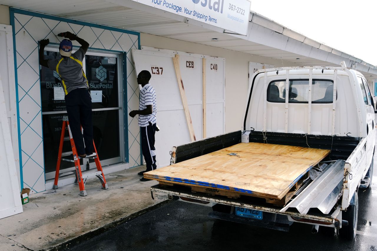Workers install storm shutters Saturday ahead of Hurricane Dorian's arrival in Marsh Harbour on the Great Abaco Island in the Bahamas.