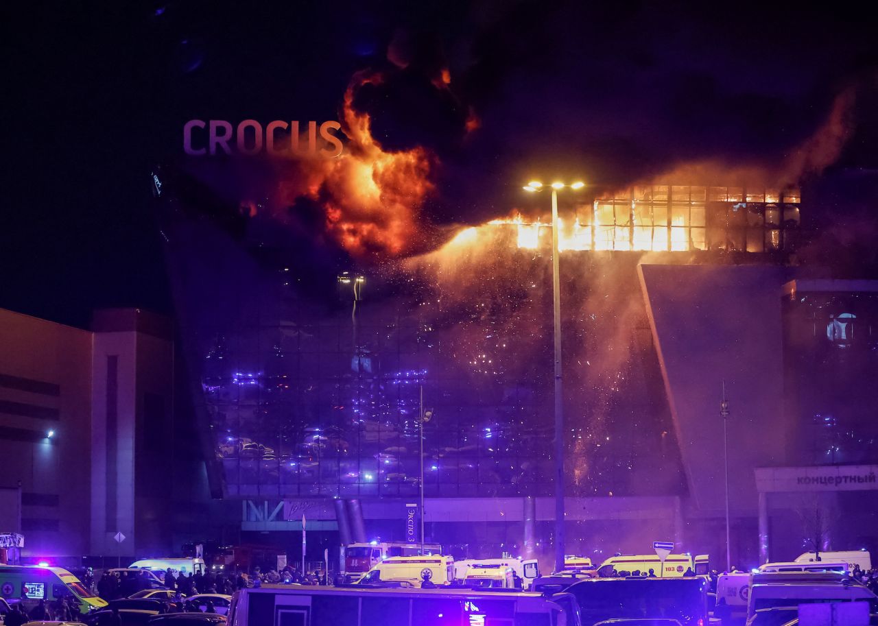 Ambulances and vehicles of?Russian emergency services are seen parked outside the burning Crocus City Hall concert venue outside Moscow on Friday.