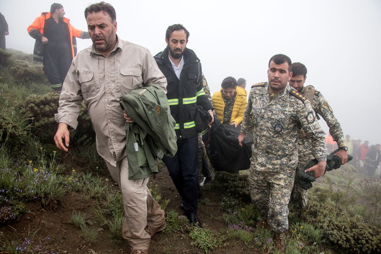 A rescue team carries a body following a?helicopter crash?carrying?Iran's President Ebrahim Raisi, in Varzaqan, Iran, on May 20.