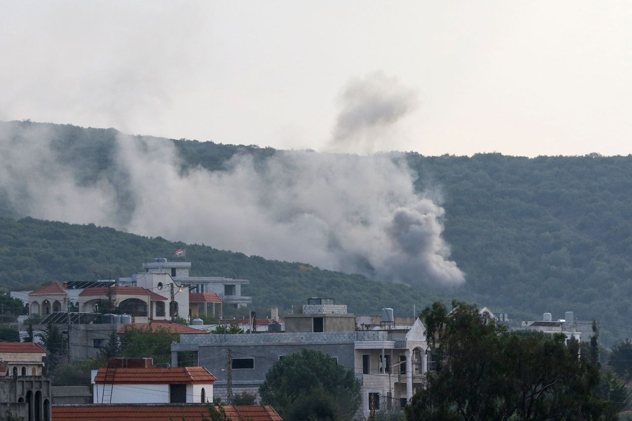 Smoke billows following Israeli artillery bombing on the outskirts of the Lebanese border village of Aita al-Shaab, on October 9.