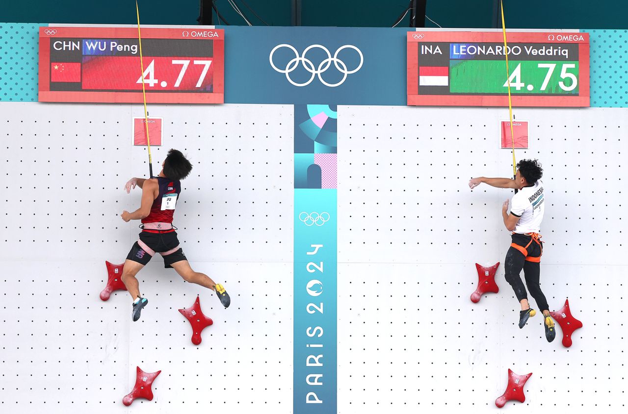 Veddriq Leonardo of Team Indonesia, right, finishes ahead of Wu Peng of Team People's Republic of China to win the gold medal during the men's speed - big final on day thirteen of the Olympic Games Paris 2024 at Le Bourget Sport Climbing Venue on August 8.