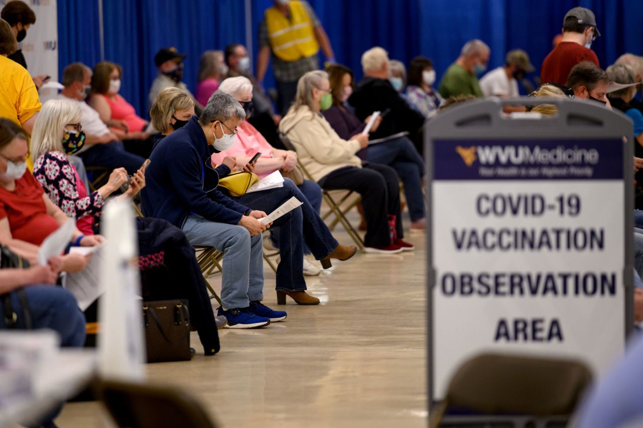 Residents wear protective masks in the observation area after being vaccinated at a West Virginia United Health System Covid-19 vaccine clinic in Morgantown, West Virginia on March 11