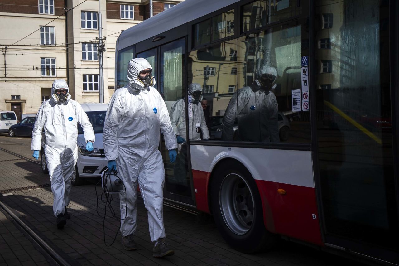 Workers wear protective clothes as they test a new disinfectant on a tram in Prague, Czech Republic, on Thursday.