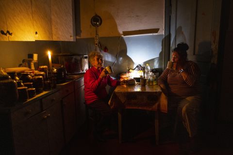 Natalia Zemko (L), 81, talks with her daughter Lesya Zemko at their home on October 22, in Kyiv, Ukraine. Restricted power supplies and limited electricity started so that energy companies could repair power facilities hit by a wave of recent Russian air strikes.