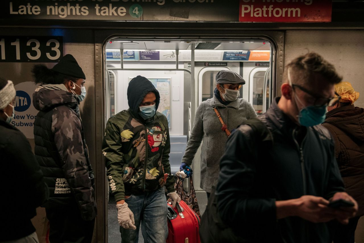 Commuters exit a subway train in New York on April 17.