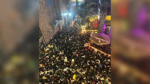 Image of a street in Itaewon district packed with people in Seoul on Saturday night. 