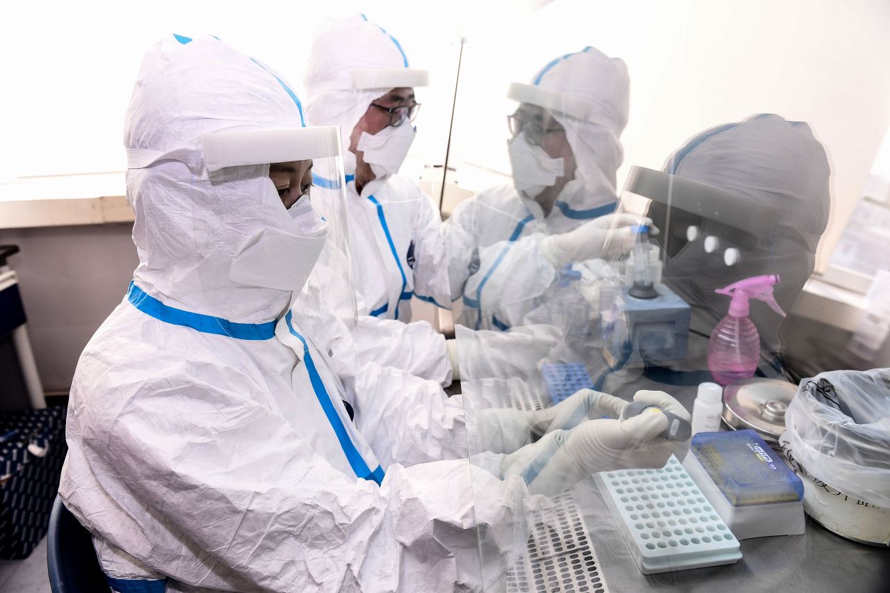 Laboratory technicians test samples from people for the coronavirus in Shenyang, China, on February 12, 2020.