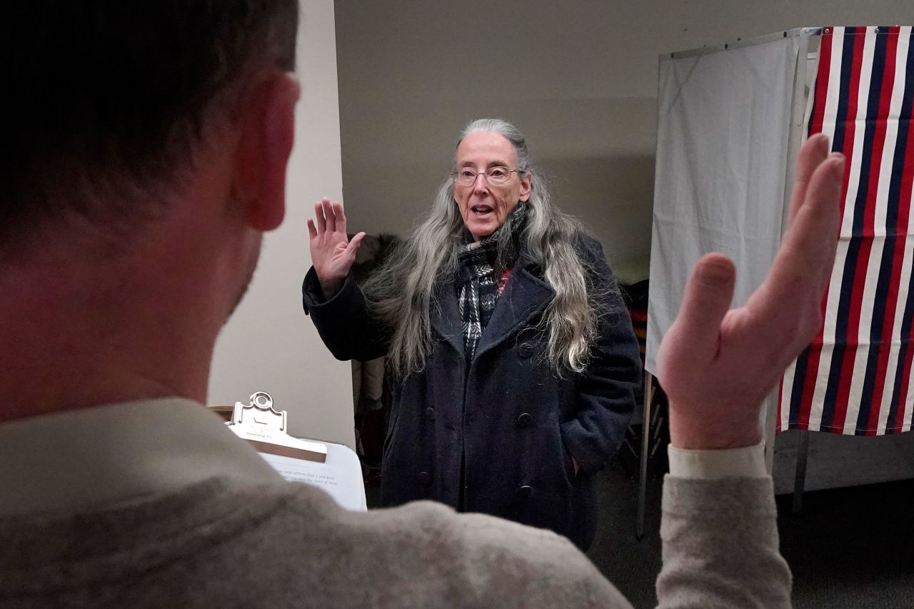 Election official Nancy Gray is sworn in before the polls open in Northumberland, New Hampshire.