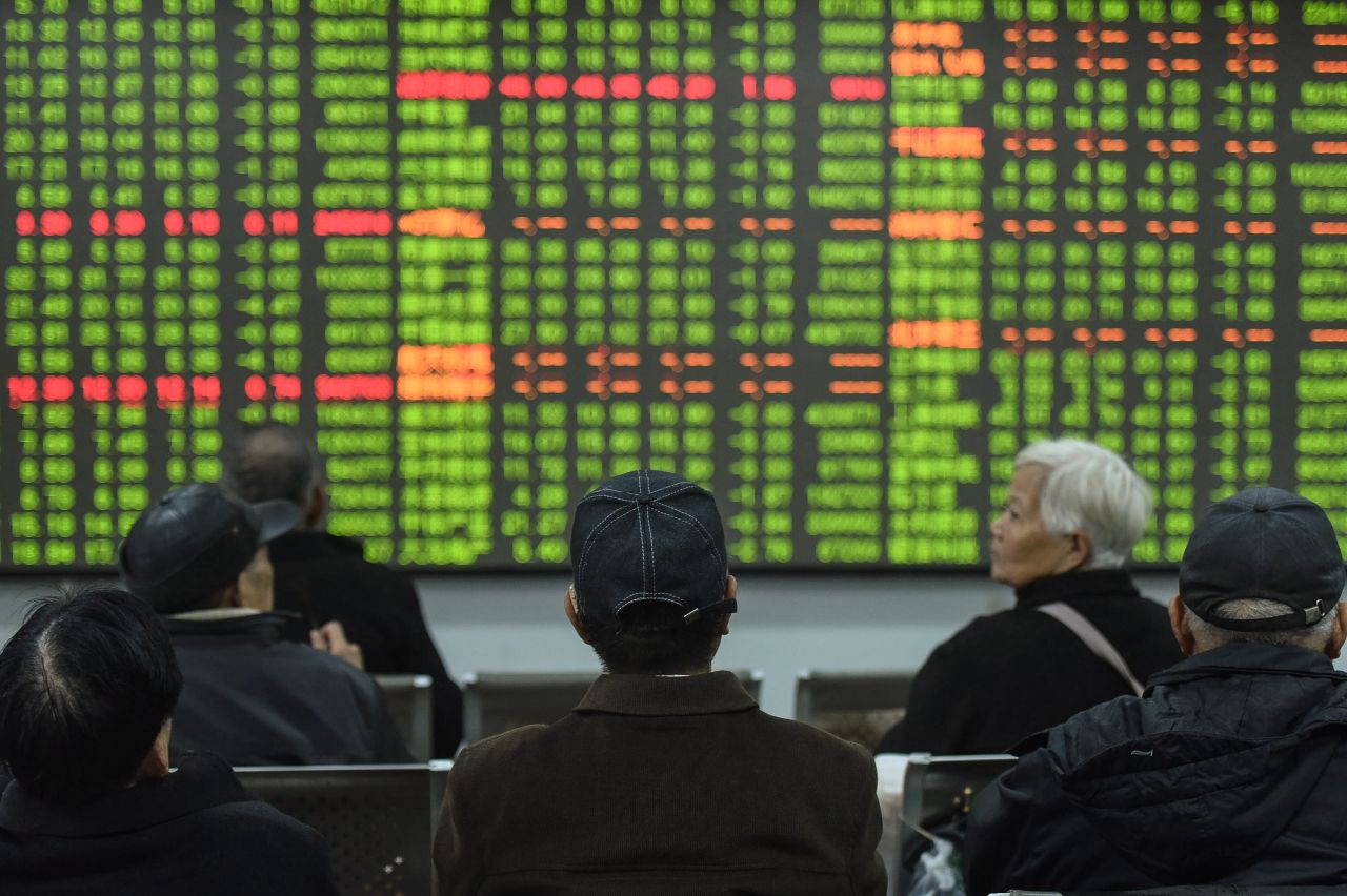 Investors look at a screen showing stock market movements in Hangzhou, China, on February 3, 2020.