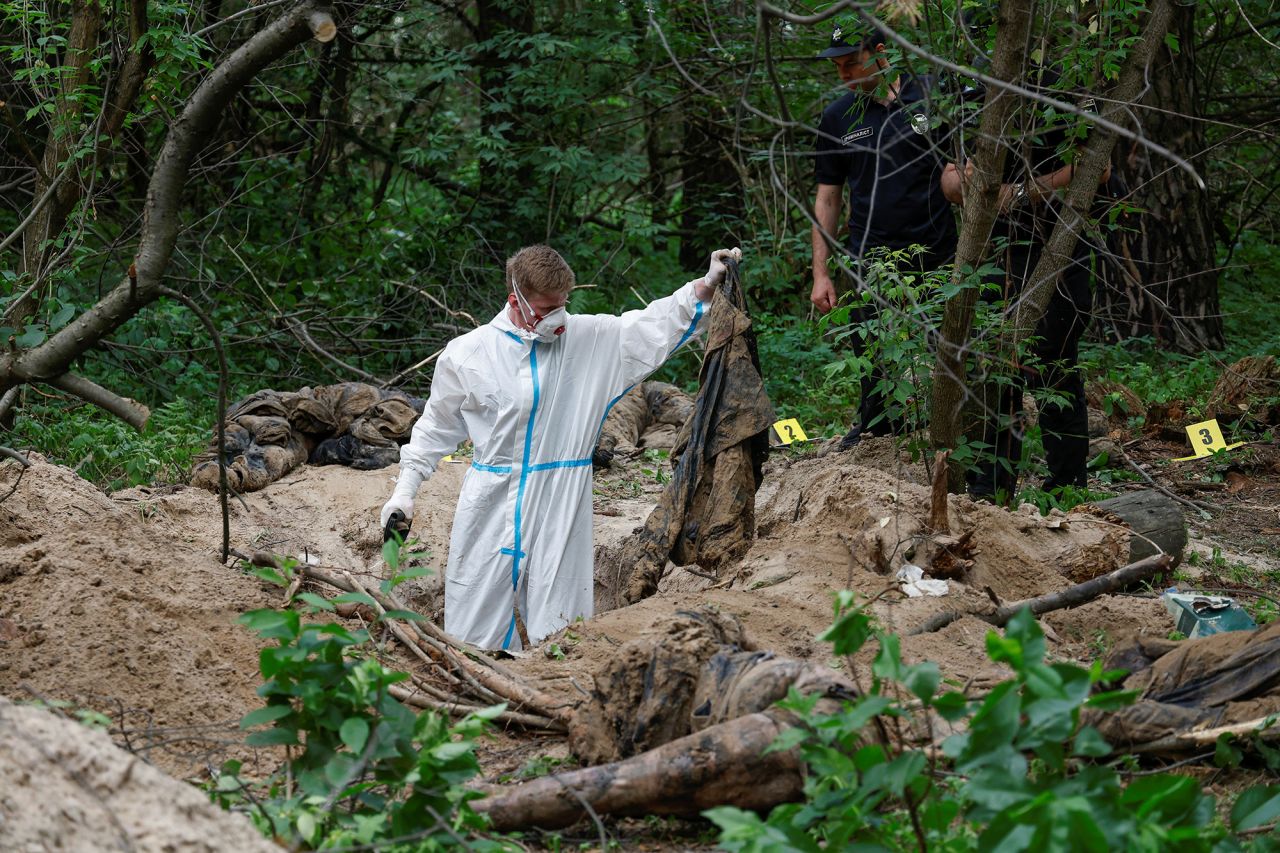 A forensic technician inspects an alleged mass grave near the village of Vorzel in?the Bucha?district, Kyiv region, Ukraine, on June 13.