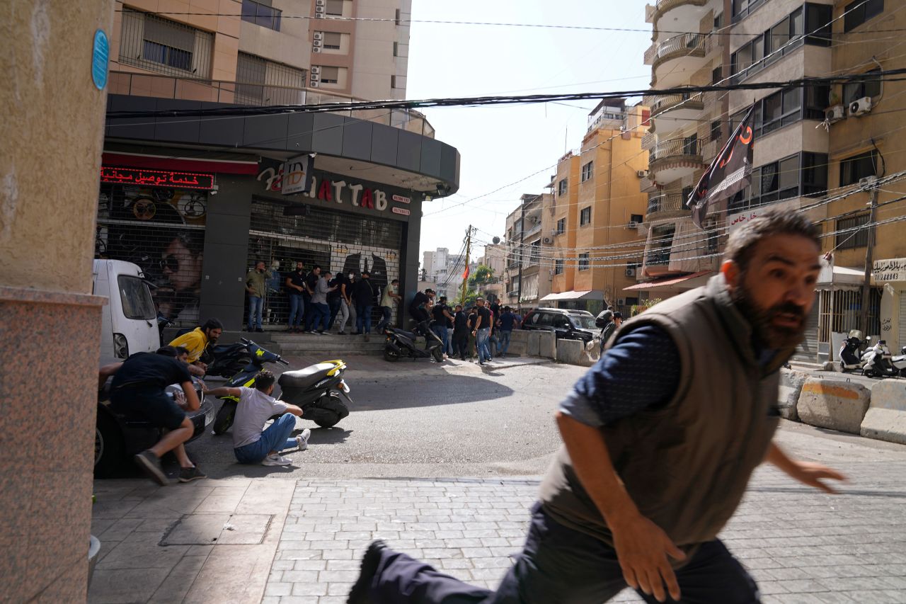 A man runs for cover as gunfire erupts in Beirut on October 14.