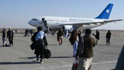 Los pasajeros caminan para abordar un avión comercial de Ariana Afghan Airlines en el Aeropuerto Internacional Khwaja Abdullah Ansari, el 23 de diciembre de 2024.