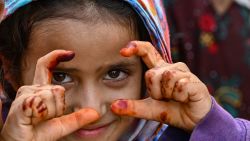 An Afghan refugee girl gestures as she prepares to depart for Afghanistan, at a holding centre, in Landi Kotal on November 1, 2023. Hundreds of thousands of Afghans living in Pakistan faced the threat of detention and deportation on November 1, as a government deadline for them to leave sparked a mass exodus. (Photo by Farooq Naeem / AFP) (Photo by FAROOQ NAEEM/AFP via Getty Images)