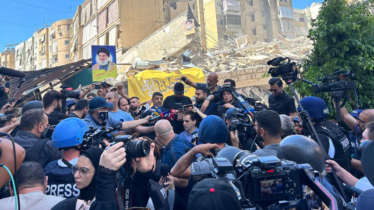 Hezbollah spokesman Mohammad Afif gives a news conference on Wednesday from the site of an Israeli airstrike.