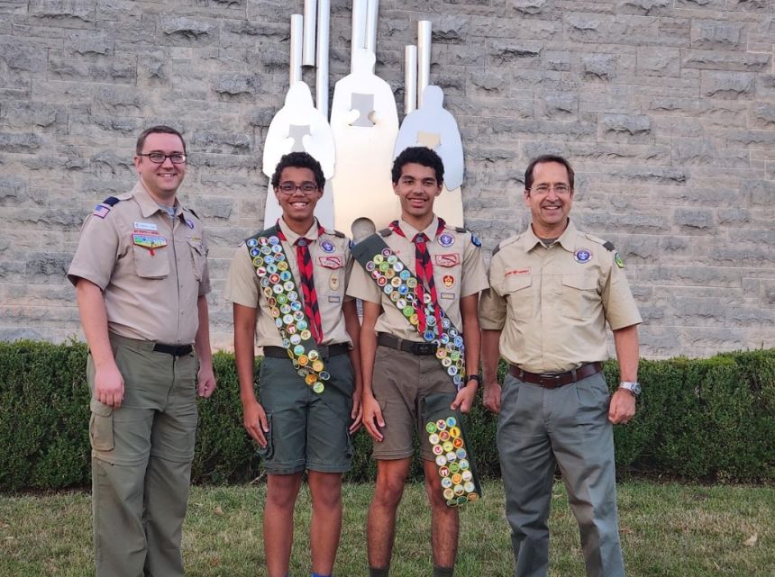 Scouts are now able to earn badges related to AI and cybersecurity. Michael Dunn, left, and Bob Caruso, right, who helped develop one of the badges, stands with scouts Charles Hendricks and Wydell Hendricks.