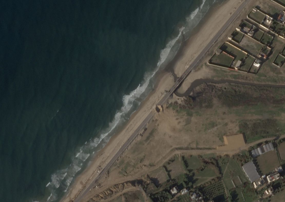 A large crater on Al Rashid Road, central Gaza, first visible in satellite imagery from last December, is seen in an image taken on January 29, 2024. Despite the crater, the Israeli military designated the coastal road as the main route for humanitarian convoys from January 4, 2024.