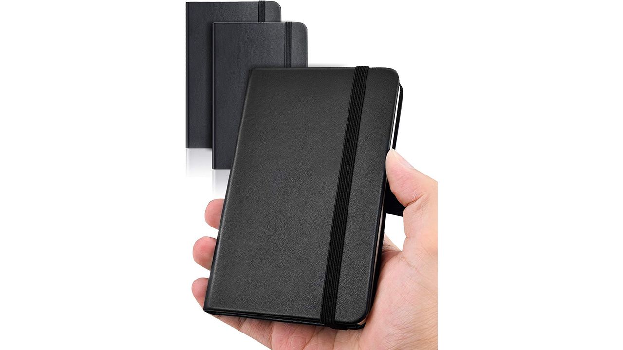 A photo of a hand holding a black Aisbugur Pocket Notebook