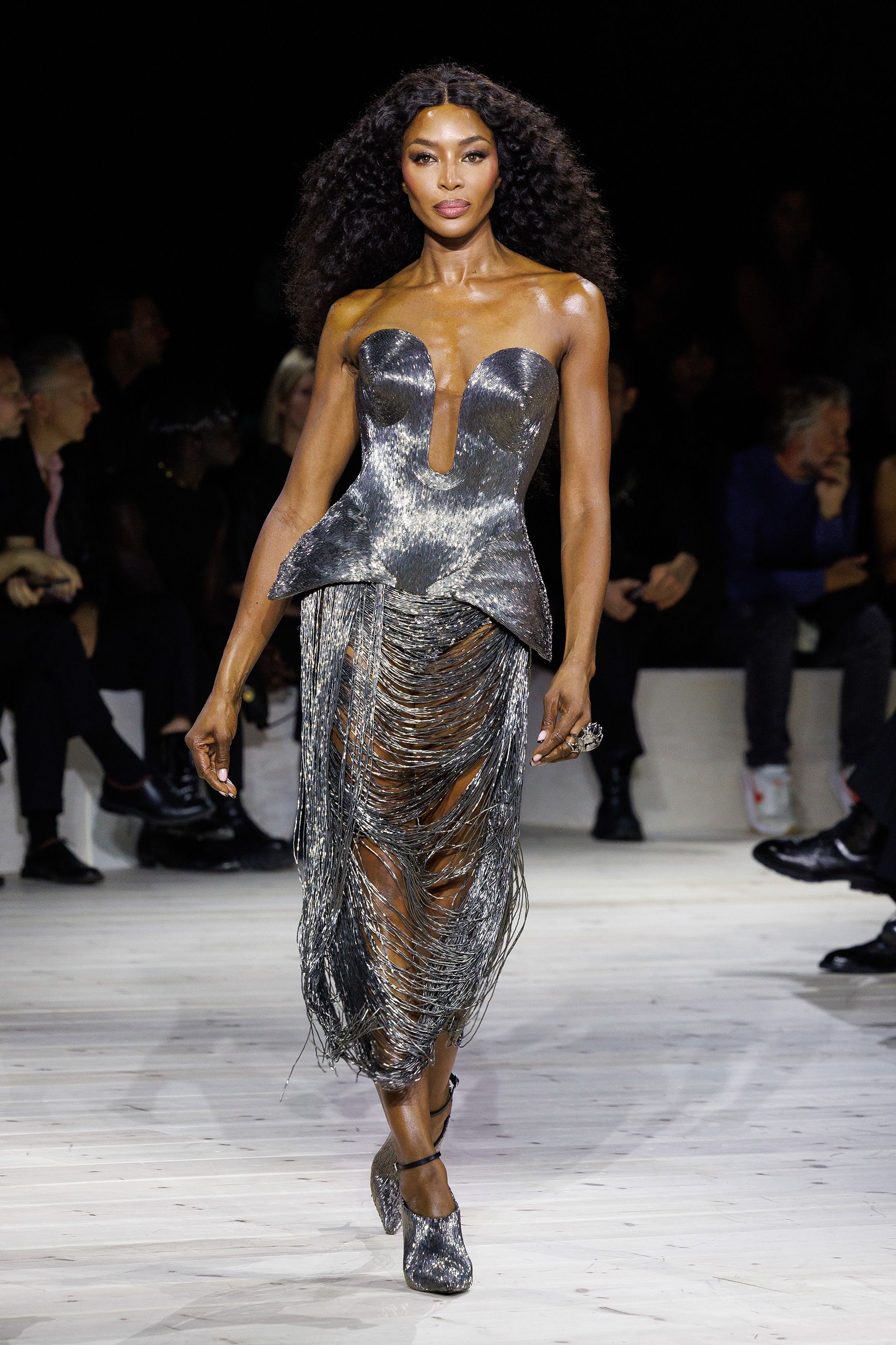 Naomi Campbell closed the show to a standing ovation from showgoers, wiping tears from her face.