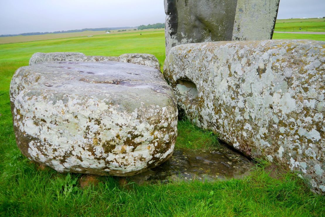 The Altar Stone can be seen underneath two bigger sarsen stones.